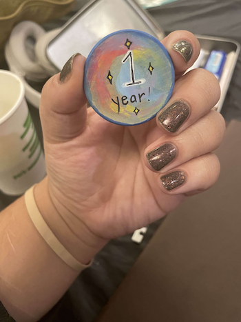my one year chip: a handpainted wooden chip that says '1 year!